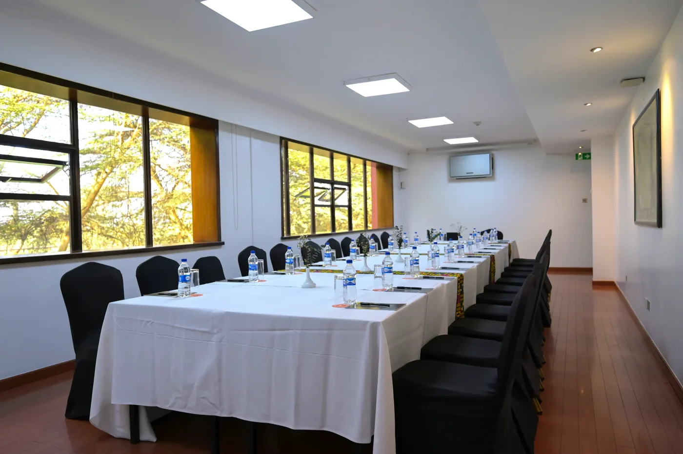 A long boardroom table set for a meeting, overlooking Ole Sereni's gardens