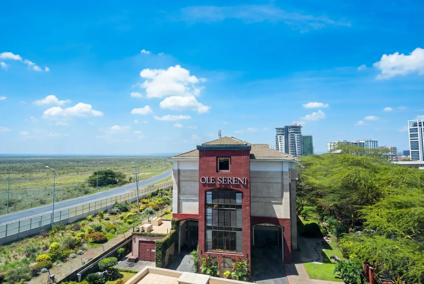 Aerial view of the Ole Sereni hotel on Mombasa Road, its red entrance tower rising above open grassland
