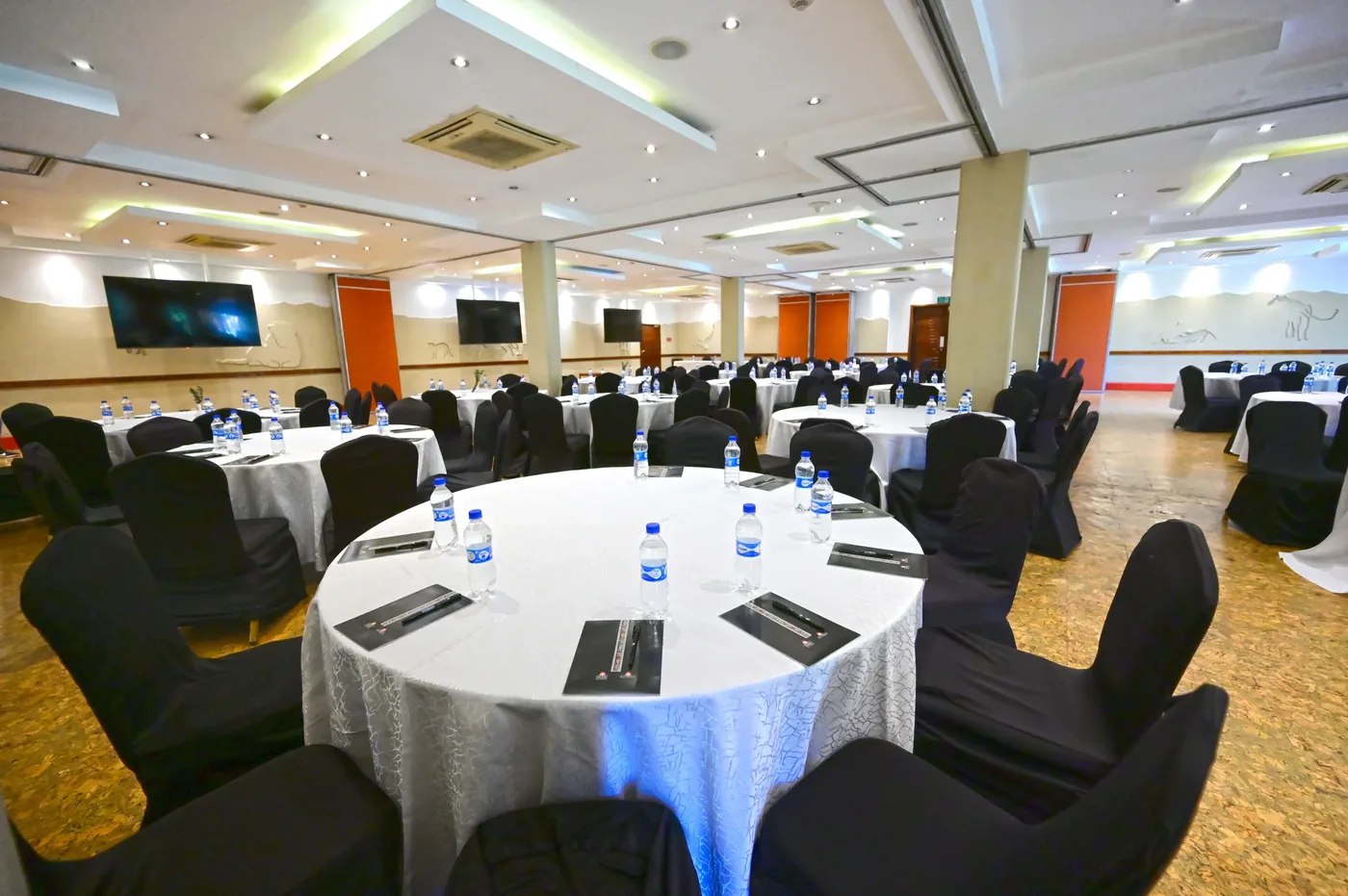 Ole Sereni's Pride Hall laid out banquet-style with round tables for a conference