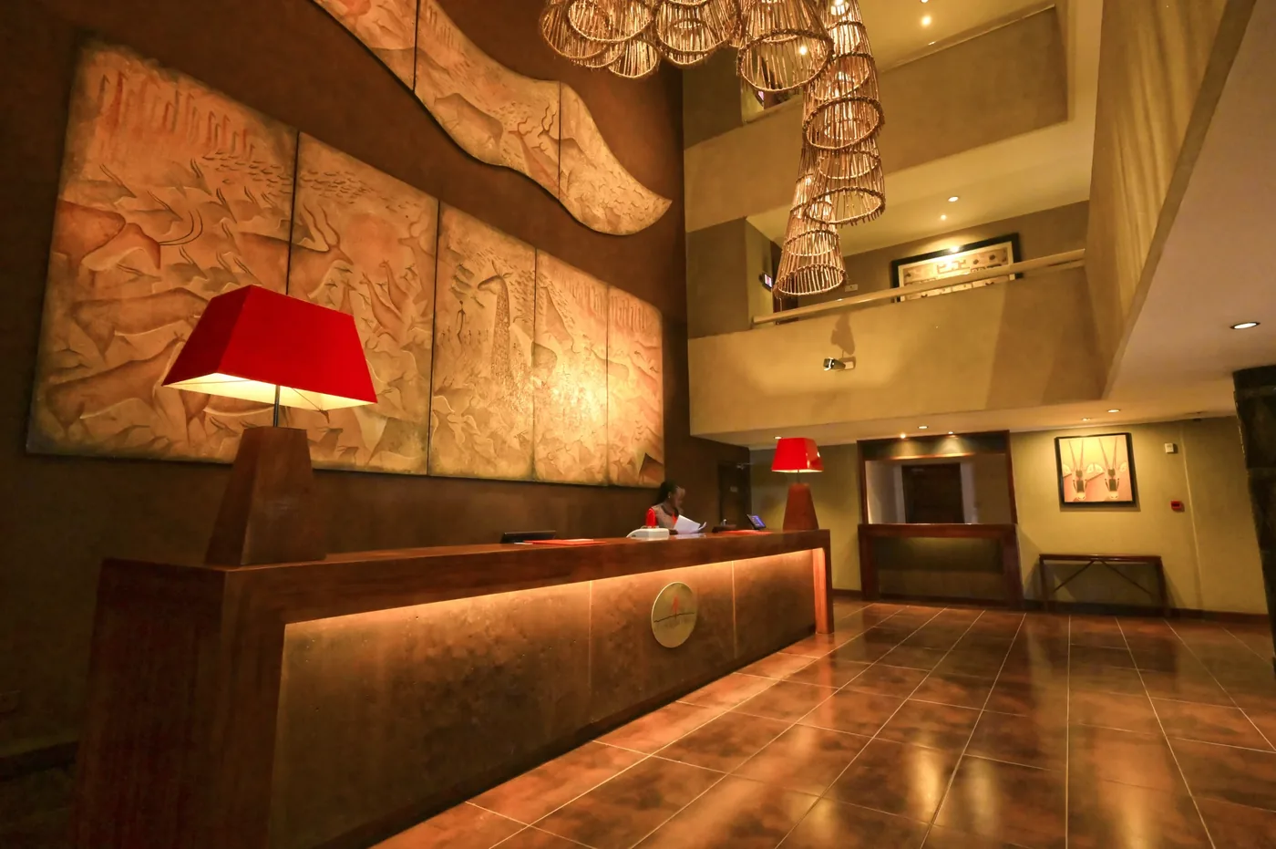 Ole Sereni's reception desk beneath woven pendant lights